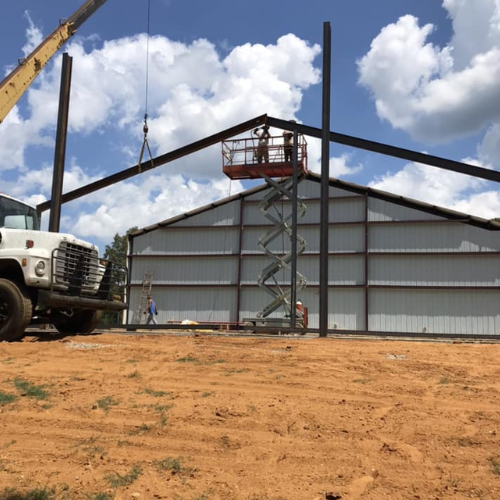 A building getting welding done to its roof